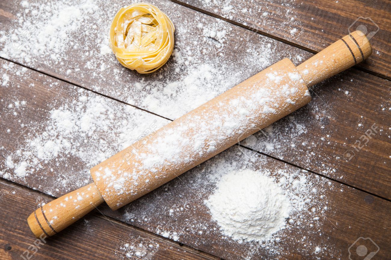 Wooden rolling pin with flour and pasta Proceli